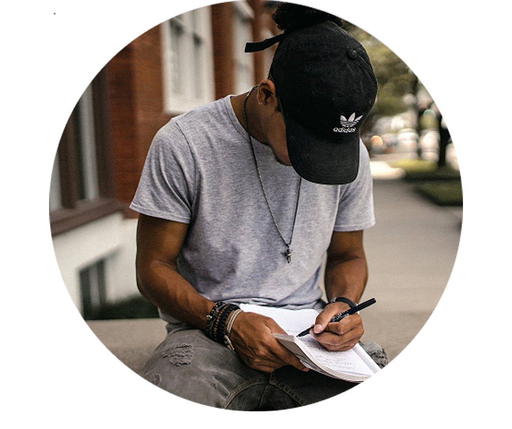 Photo of a man writing notes in a notepad