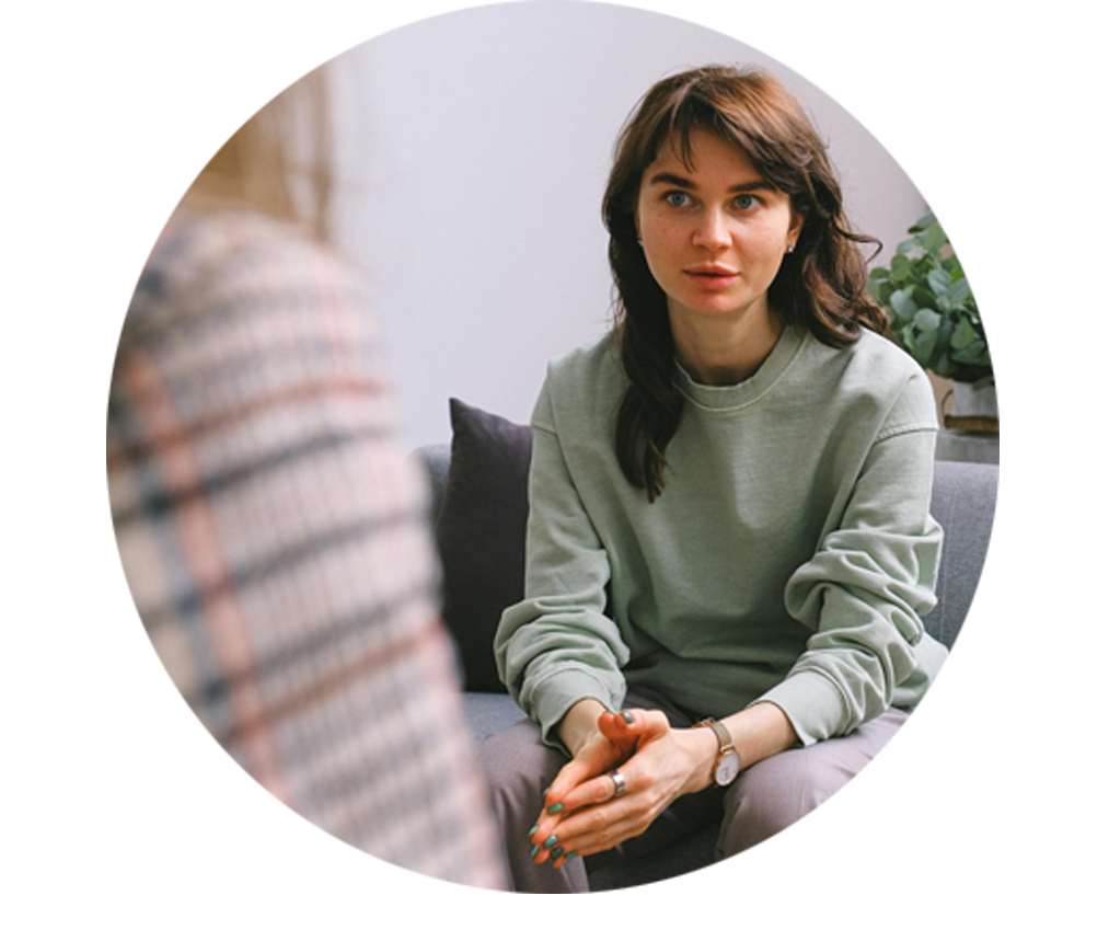 Photo of a woman talking with someone on a couch